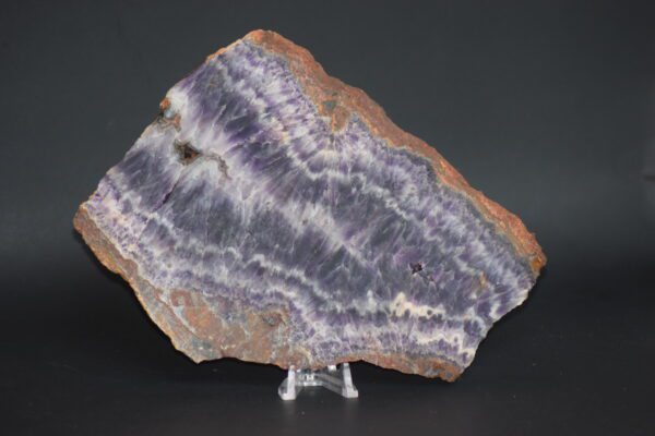 A slab of purple and white rock on top of a stand.