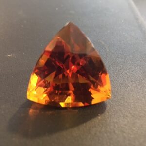 A large orange stone sitting on top of a table.