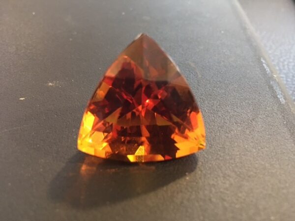 A large orange stone sitting on top of a table.