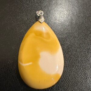 A Mookaite Jasper Sterling Silver Pendant on a black surface.